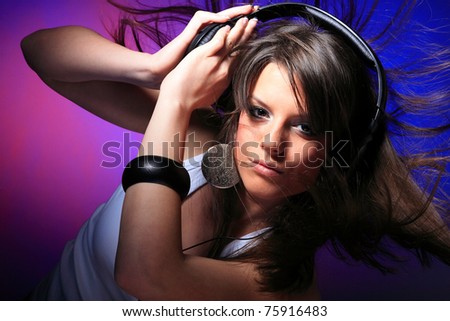 girl enjoys music over colorful background