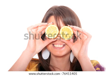 A pretty young woman with lemon in front of her eyes
