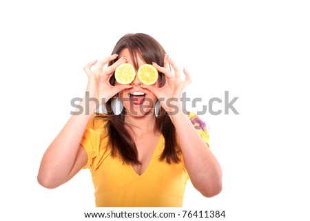 Happy  young woman with lemon in front of her eyes