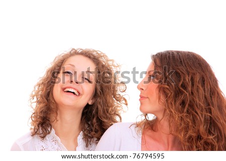 Two girl friends smiling over white background