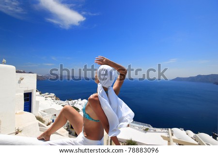 Young woman enjoying the view of  Santorini island Greece