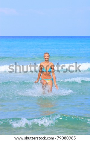 Energetic and satisfied woman on the beach in Greece
