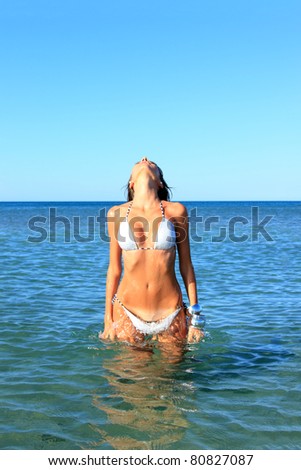 Beautiful young woman relaxing on the beach in Greece