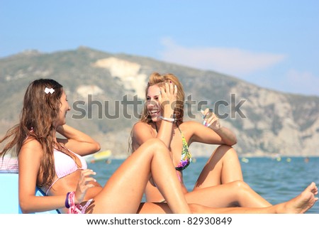 Two beautiful young women on a pedalo boat
