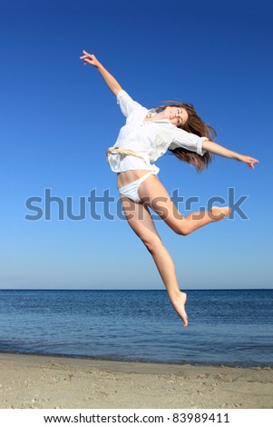 Sexy model jumping on the beach