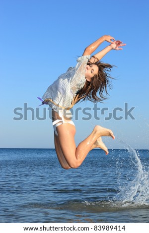 Sexy model jumping on the beach