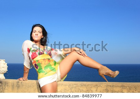 Beautiful girl relaxing outdoor at summer lounge beach club in Greece