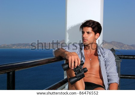 Man with field-glass by the sea in Greece