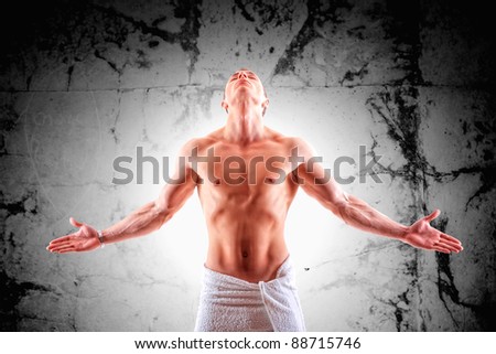 Handsome muscular man in towel with open arms