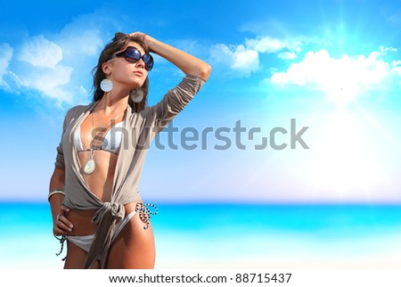 Beautiful girl on the beach enjoying the Ionian sea in Greece