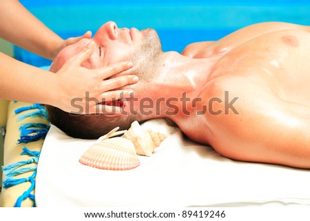 Man receiving massage relax treatment close-up from female hands