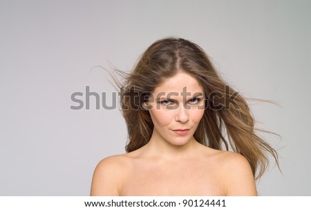Beautiful face of young woman over neutral background