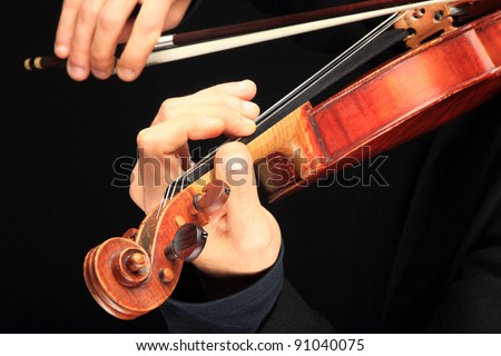 Violin player close up on black