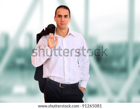 Closeup of a young business man hands in pocket standing in a light and modern business hall.