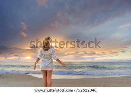 Woman on the beach at sunset in south east Asia
