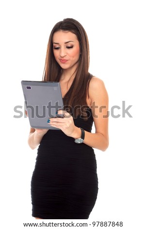 Happy brunette woman holding in hand a tablet touch pad computer and smiling on a white background