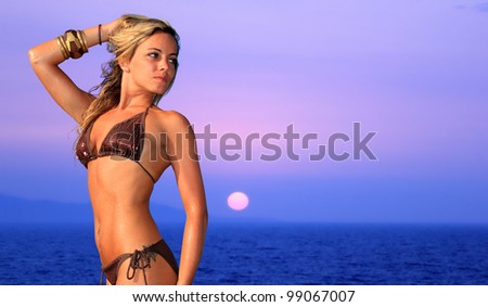 Beautiful young woman relaxing by the beach at sunset in Greece