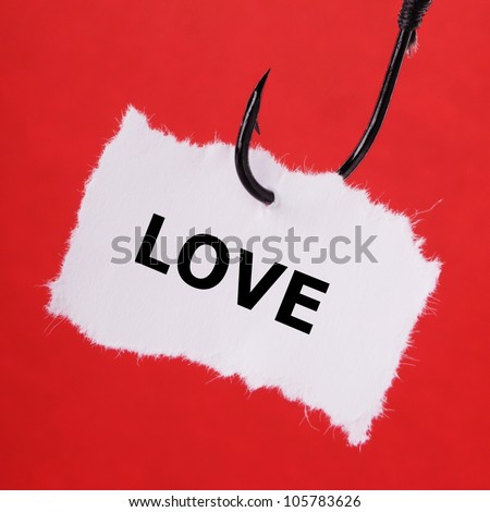 paper note on fishing hook on red background