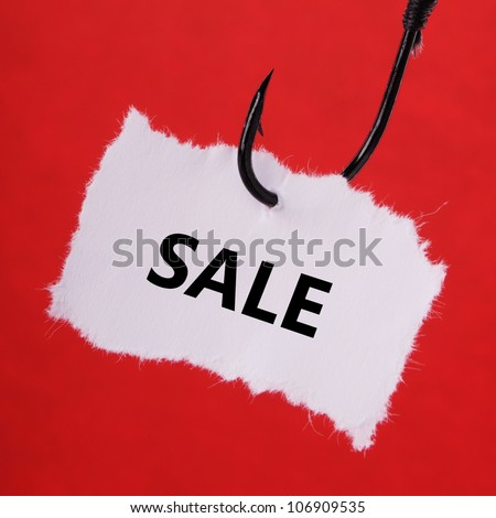 paper note on a fishing hook on red background