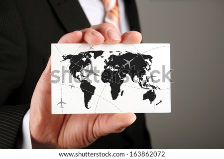 businessman holding a business card with his travel route to his cooperation partners
