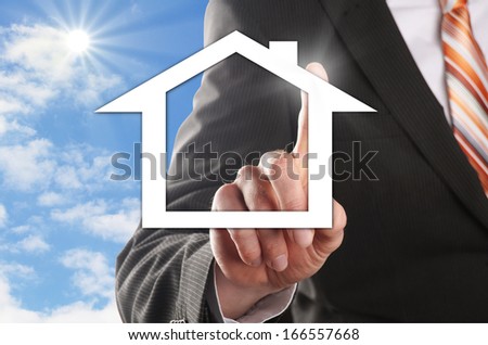 man chooses his dream house in front of the blue sky