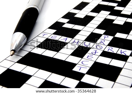 a shot of a crossword puzzle and pen