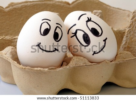 stock photo : white eggs with different faces in a packet
