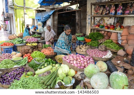 BANGALORE, IN - JANUARY 09: Vendor sells produce on an unnamed street in Bangalore, IN January 09, 2013 in Bangalore, India. 42% of India falls below the international poverty line of $1.25 a day.
