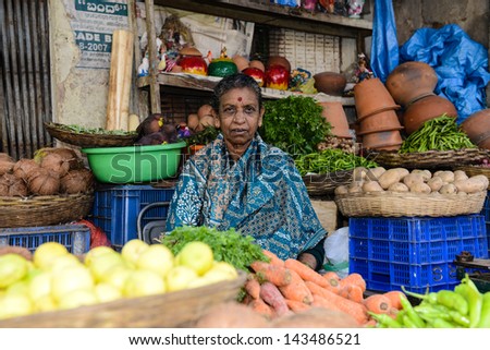 BANGALORE, IN - JANUARY 09: Vendor sells produce on an unnamed street in Bangalore, IN January 09, 2013 in Bangalore, India. 42% of India falls below the international poverty line of $1.25 a day.