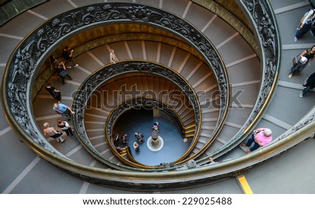 VATICAN - OCTOBER 18: Unidentified people go down spiral stairs in Vatican Museums on October 18, 2014 in Vatican. Vatican City is the smallest independent state in the world.
