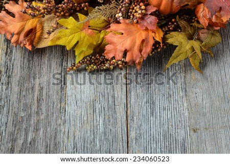 Autumn leaves and berry over wooden background for Thanksgiving
