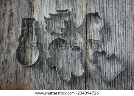 Holiday Cookie Cutters on Rustic Wood Background