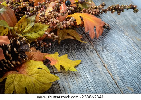 Autumn leaves and berry over wooden background for Thanksgiving