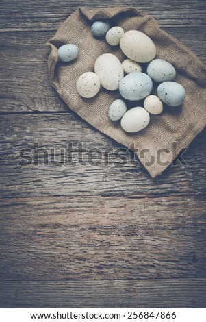 Easter Eggs on Rustic Wooden Background with Retro Instagram Style Filter