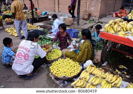 BANGALORE, IN - JUNE 26: Poor Vendor sells fruit on an unnamed street in Bangalore, IN June 26, 2011 in Bangalore, India. 42% of India falls below the international poverty line of $1.25 a day.