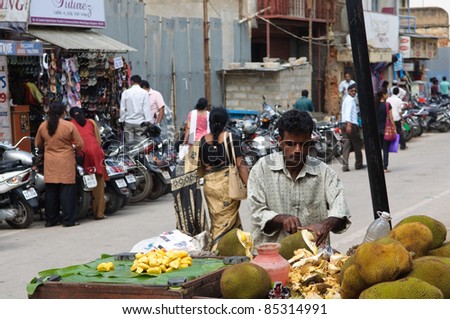 BANGALORE, IN - JUNE 30: A street vendor sells coconuts on June 30, 2011 in Bangalore, India. 42% of India falls below the international poverty line of $1.25 a day.