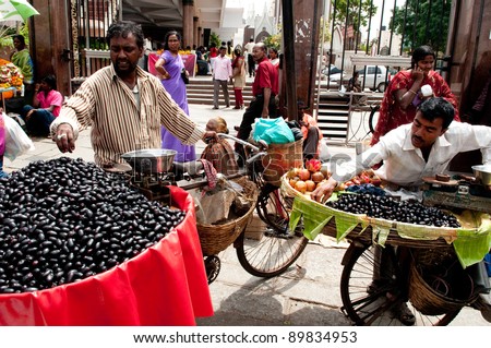 BANGALORE, IN - JUNE 26: Vendors selling fruit on an unnamed street in Bangalore, IN June 26, 2011 in Bangalore, India. 42% of India falls below the international poverty line of $1.25 a day.