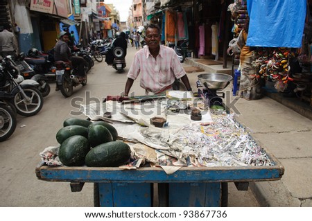BANGALORE, IN - JUNE 30: Vendor sells watermelons on an unnamed street in Bangalore, IN June 30, 2011 in Bangalore, India. 42% of India falls below the international poverty line of $1.25 a day.