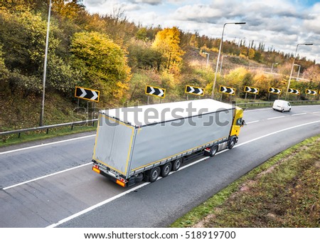 Lorry on the road in autumn scenery