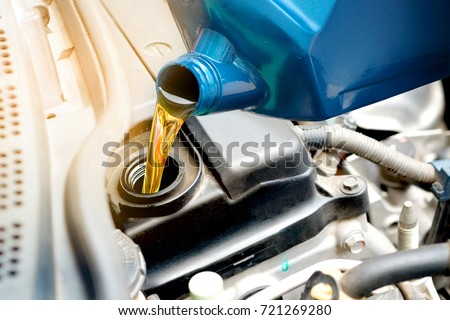 Refueling and pouring oil into the engine motor car. Energy fuel concept.