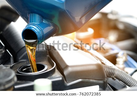 Refueling and pouring oil quality into the engine motor car Transmission and Maintenance Gear.Energy fuel concept.