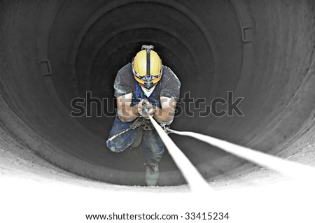 Climbing industrial worker in the H-150m 3m wide chimney