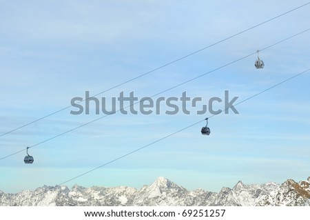 Winter Holiday Gondola Ski Lift Above Alps Mountains