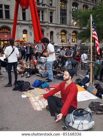 NEW YORK - SEPT.: A young man meditates amid the Occupy Wall Street demonstration near the New York Stock Exchange on September 21, 2011 in New York City.