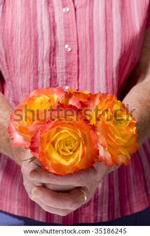 Senior person holding a Bouquet of roses? tequila sunrise