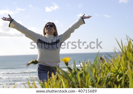 women with jumper on at beach, Mount  Maunganui, New Zealand