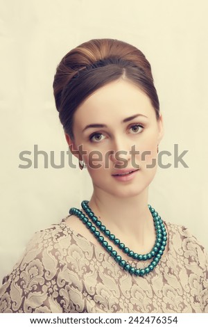 Elegant brunette retro woman with beautiful hairdo