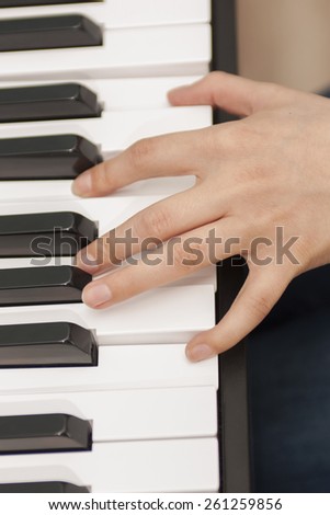 Hand of the musician on the piano keys