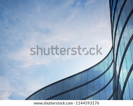 Perspective of high rise building and dark steel window system with clouds reflected on the glass.Business concept of future architecture,lookup to the angle of the building corner. 3d rendering