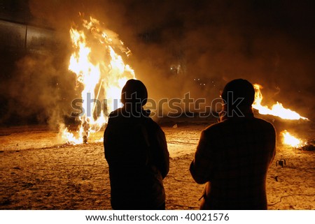 Two men looking at the fire